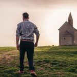 man walking in green grass