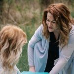 a woman looking at another woman