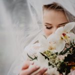 woman holding white flower bouquet