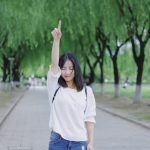 woman raising her right arm