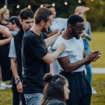man in black t-shirt standing beside woman in white t-shirt