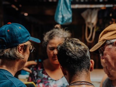 a group of people standing around each other