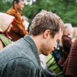 man sitting on chair near people sitting on chair during daytime