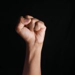 persons right hand doing fist gesture