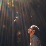 man in black jacket singing