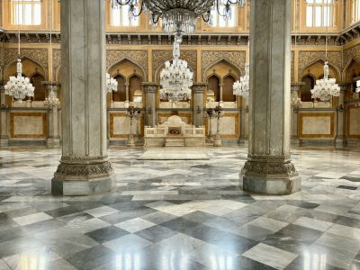 a chandelier hanging from a ceiling in a large room