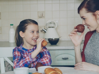 Mother and daughter enjoy breakfast together.