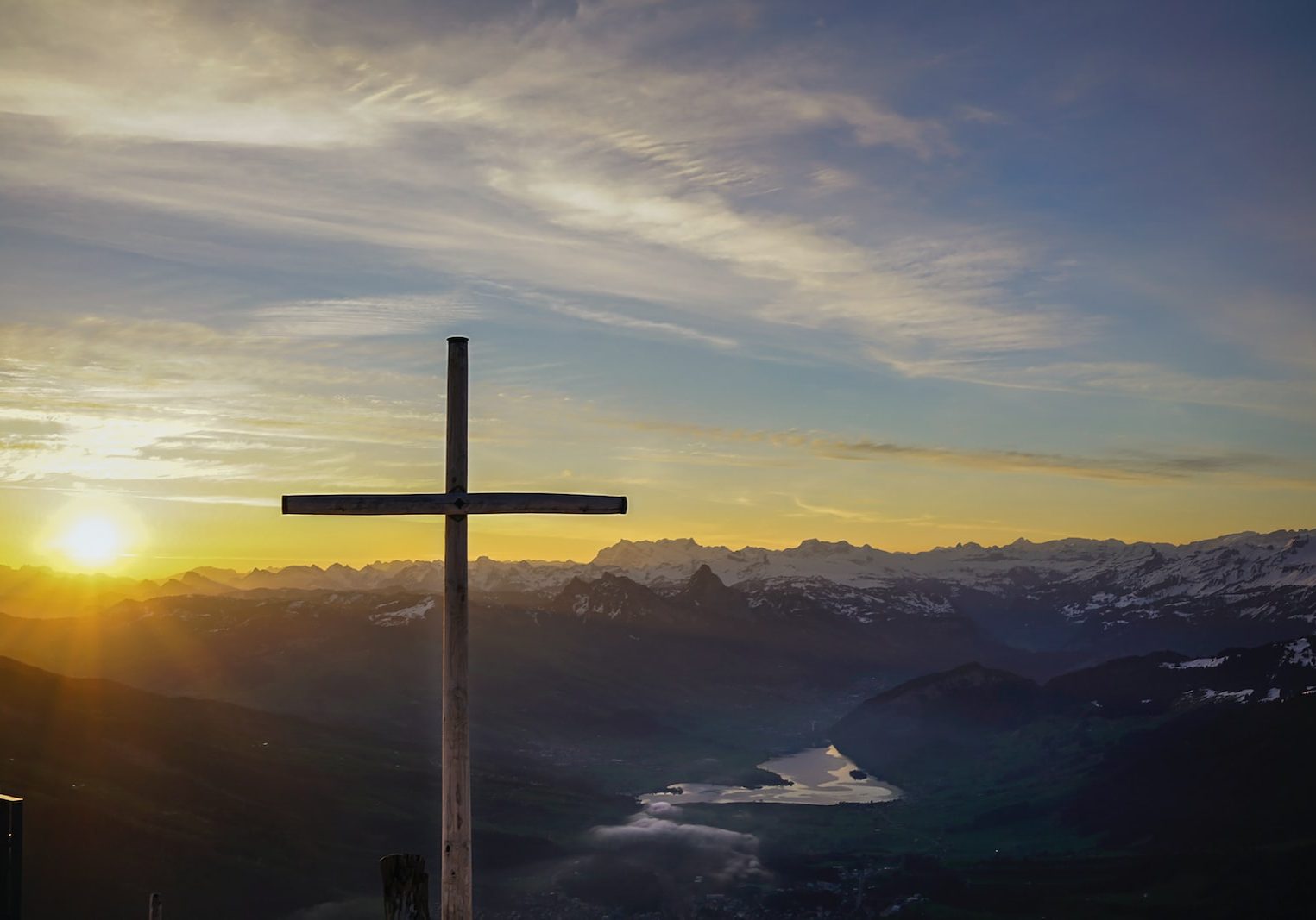 brown cross on mountain